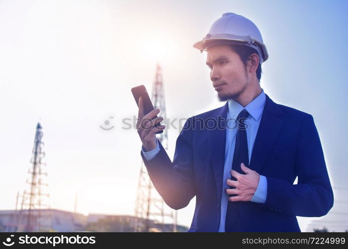 Businessman Asian call mobile phone cell phone working at construction building estate background,Technology communication concept