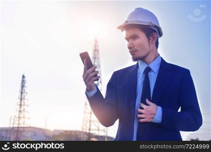 Businessman Asian call mobile phone cell phone working at construction building estate background,Technology communication concept
