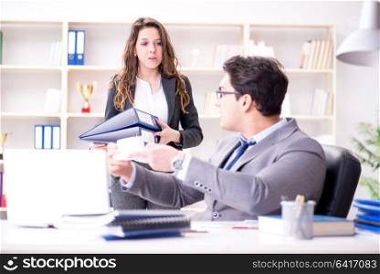 Businessman asking for paperwork from his assistant secretary