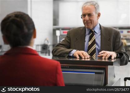 Businessman at a ticket counter in an airport
