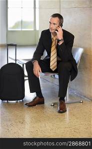 Businessman at Airport Using Cell Phone