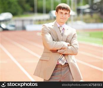 Businessman at athletic stadium and race track. Businessman sport manager and executive at athletic stadium and race track