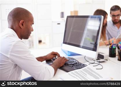 Businessman At Computer In Office Of Start Up Business