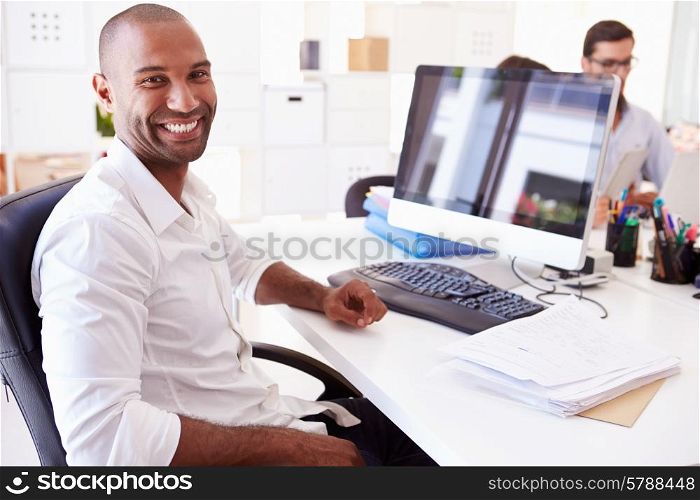 Businessman At Computer In Office Of Start Up Business