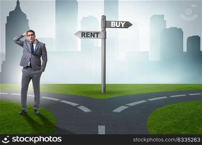 Businessman at crossroads betweem buying and renting