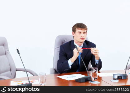 Businessman at meeting. Image of young businessman sitting at table at business meeting