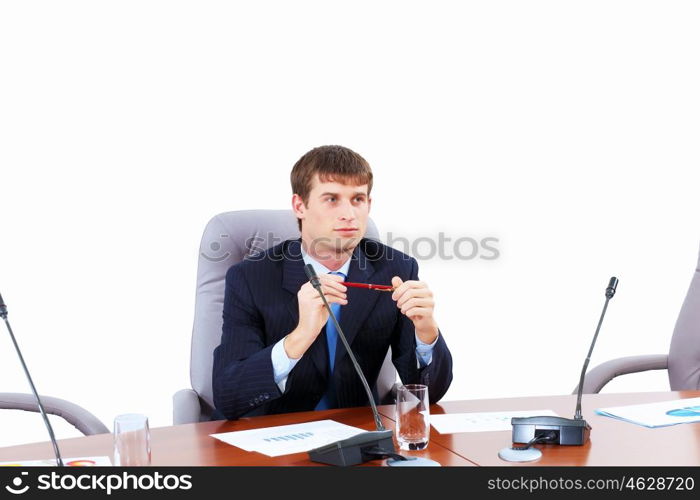 Businessman at meeting. Image of young businessman sitting at table at business meeting