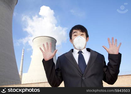 Businessman at power plant with face mask