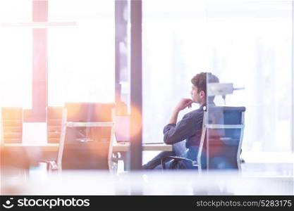 Businessman at the work in his bright office trying to resolve problem