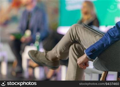 Businessman attends a press conference, actively participating and contributing to the informative discussions and engaging atmosphere. Businessman Engaged at Press Conference