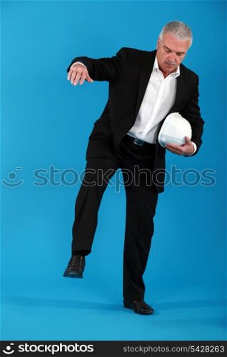 Businessman balancing on one leg