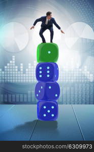 Businessman balancing on top of dice stack in uncertainty concept. Businessman balancing on top of dice stack in uncertainty concep