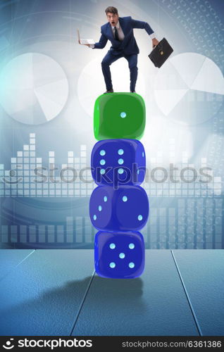 Businessman balancing on top of dice stack in uncertainty concept. Businessman balancing on top of dice stack in uncertainty concep