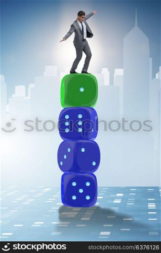 Businessman balancing on top of dice stack in uncertainty concept. Businessman balancing on top of dice stack in uncertainty concep