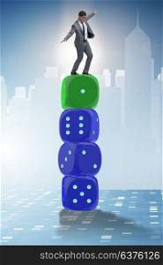 Businessman balancing on top of dice stack in uncertainty concept. Businessman balancing on top of dice stack in uncertainty concep