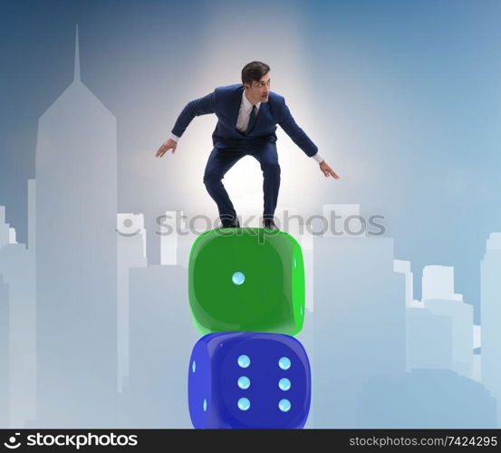 Businessman balancing on top of dice stack in uncertainty concept. Businessman balancing on top of dice stack in uncertainty concep