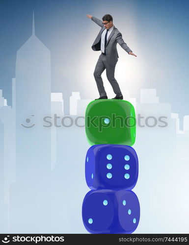 Businessman balancing on top of dice stack in uncertainty concept. Businessman balancing on top of dice stack in uncertainty concep