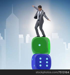 Businessman balancing on top of dice stack in uncertainty concept. Businessman balancing on top of dice stack in uncertainty concep