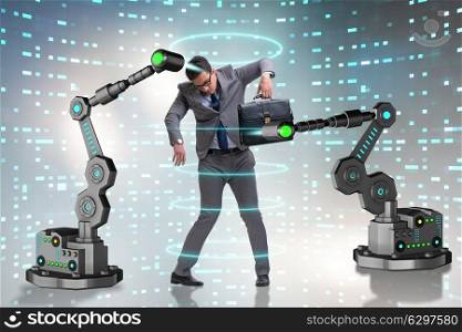 Businessman being manipulated by robotic arms