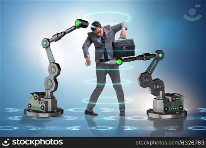 Businessman being manipulated by robotic arms