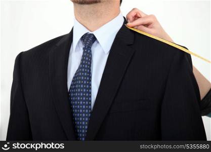 Businessman being measured for a suit