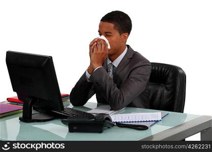 Businessman blowing his nose