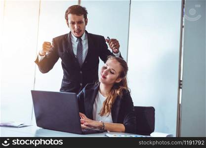 Businessman boss feels angry and mad at bad misbehaving businesswoman employee who ignores the work tasks at the workplace. Firing workers and human resources management problem concept.