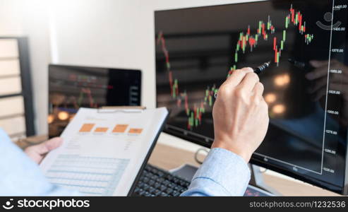 Businessman broker Analyzing finance data graphs and reports on screen for investment purposes for trading graph of stock market