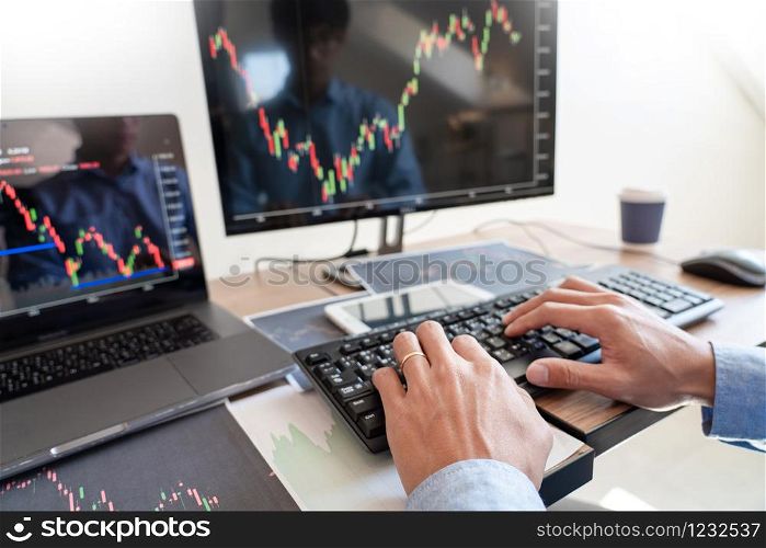Businessman broker Analyzing finance data graphs and reports on screen for investment purposes for trading graph of stock market