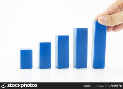 Businessman building a growing financial graph using wood toy, finance successful business concept