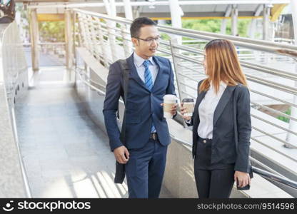 Businessman Businesswoman drink coffee in town outside office modern city. Hands holding take away coffee cup talking together happy fun. Partner Business people formal suit with cup of coffee