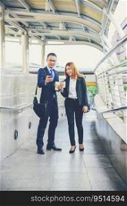 Businessman Businesswoman drinking coffee in town using smartphone outside office modern city. Hands holding take away coffee cup and smart phone talking together Business partner with cup of coffee