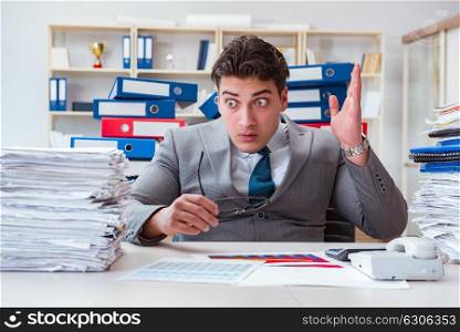Businessman busy with much paperwork
