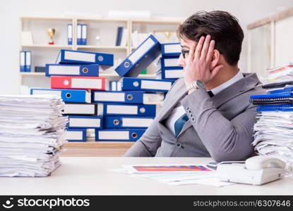 Businessman busy with much paperwork