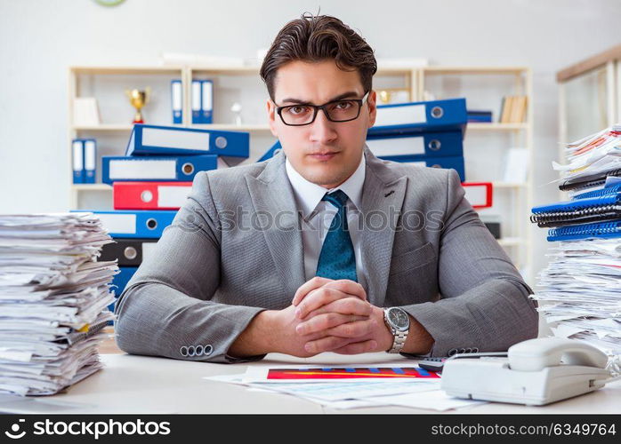 Businessman busy with much paperwork