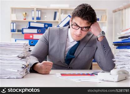 Businessman busy with much paperwork. The businessman busy with much paperwork