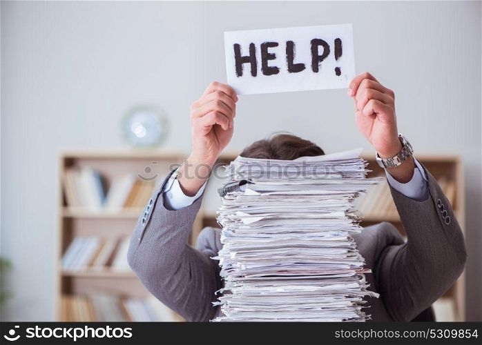 Businessman busy with paperwork in office