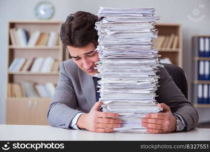 Businessman busy with paperwork in office