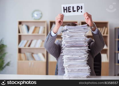 Businessman busy with paperwork in office