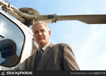 Businessman by helicopter low angle view