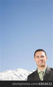 Businessman by mountains