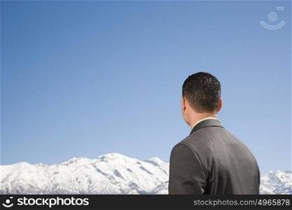 Businessman by mountains