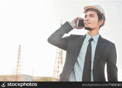 Businessman call cell phone or mobile smart phone at the construction site