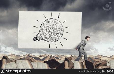 Businessman carry banner with plan. Young businessman carrying his great business plan in hands