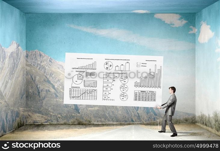 Businessman carry banner with plan. Young businessman carrying his great business plan in hands