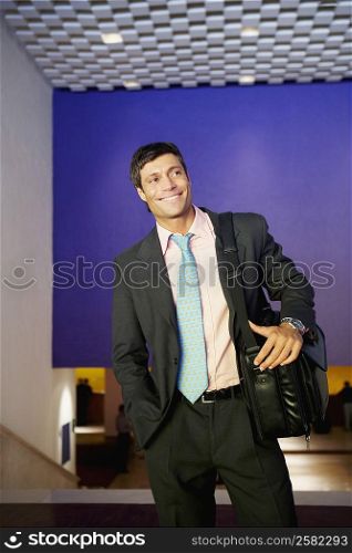 Businessman carrying a bag and smiling
