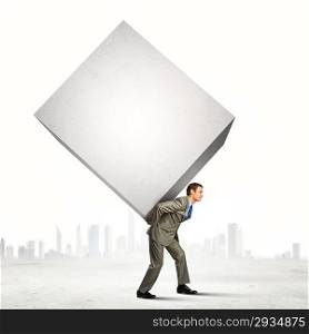 Businessman carrying cube
