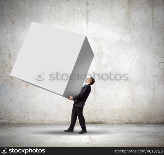 Businessman carrying cube. Young businessman carrying white big cube. Place for text