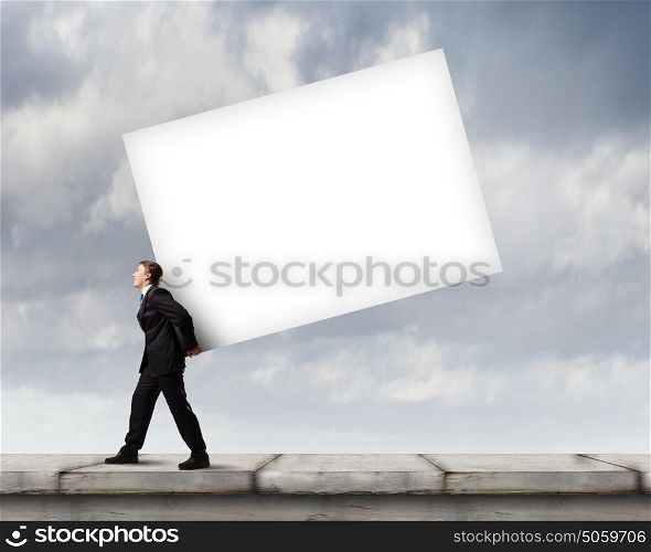 Businessman carrying cube. Young businessman carrying white big cube. Place for text