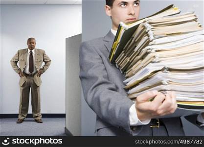Businessman carrying lots of files